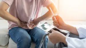 Abdominal pain patient woman having medical exam with doctor