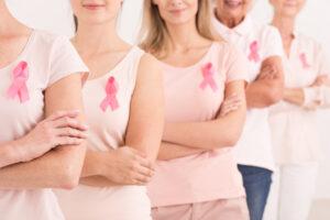women wearing pink ribbons for breast cancer campaign on white background