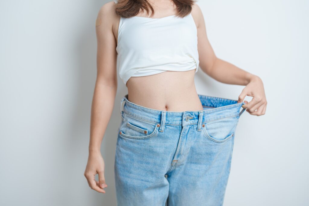 Woman showing off weight loss results
